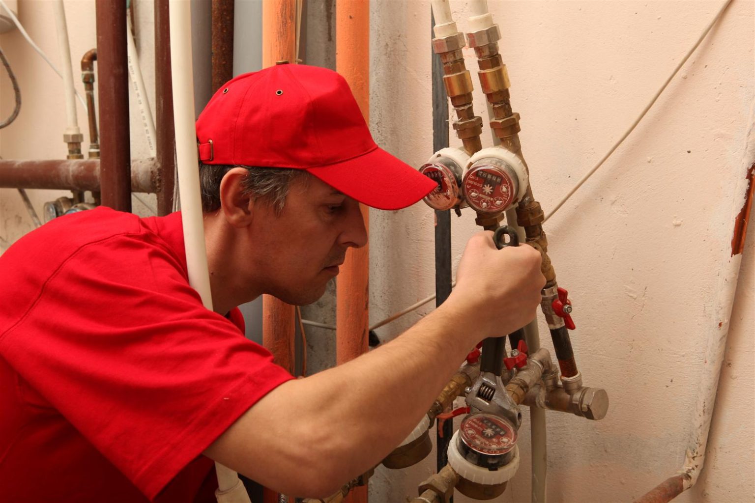 Licensed plumber working on a water heating system in NYC